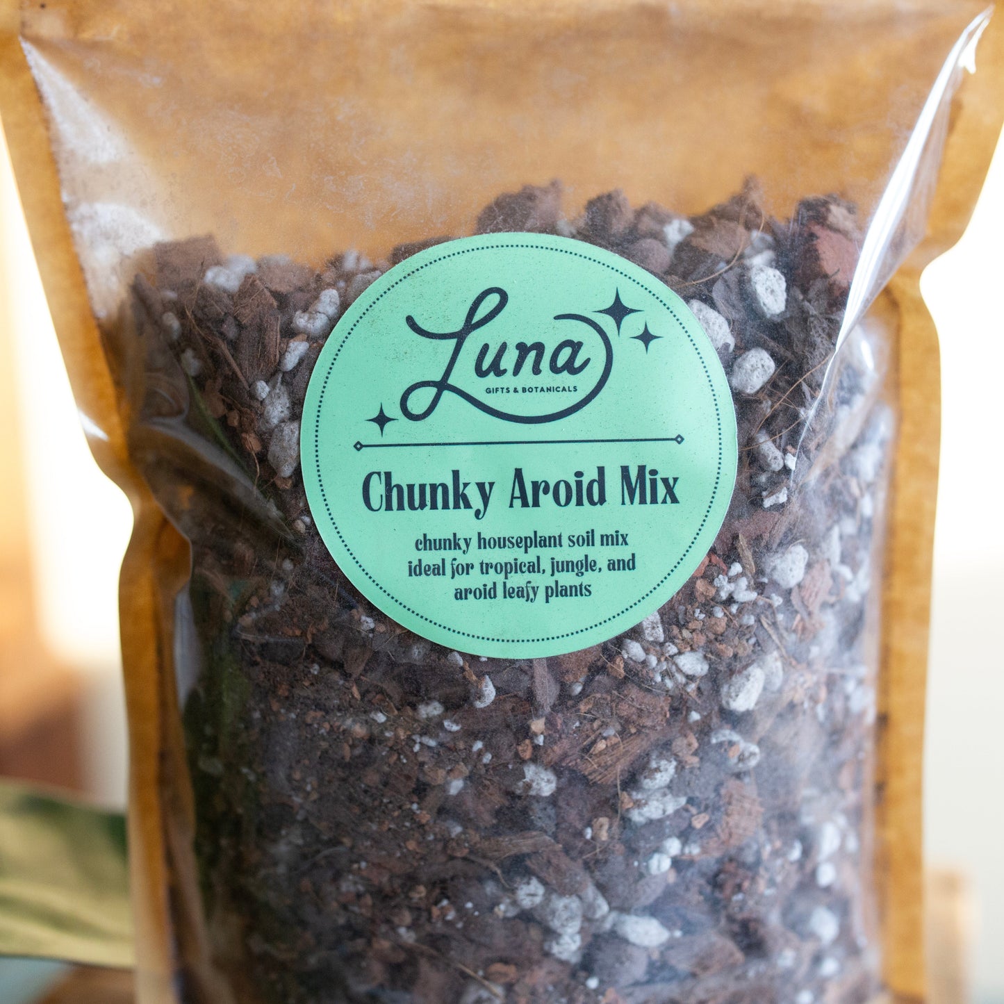 Close up of label of Bag of Luna Chunky Aroid Soil Mixture that reads "Chunky Aroid Mix; chunky houseplant soil mix ideal for tropical, jungle, and aroid leafy plants".